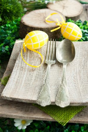 Restaurant menu series. Easter place setting. Fork and knife in rustic country table setting